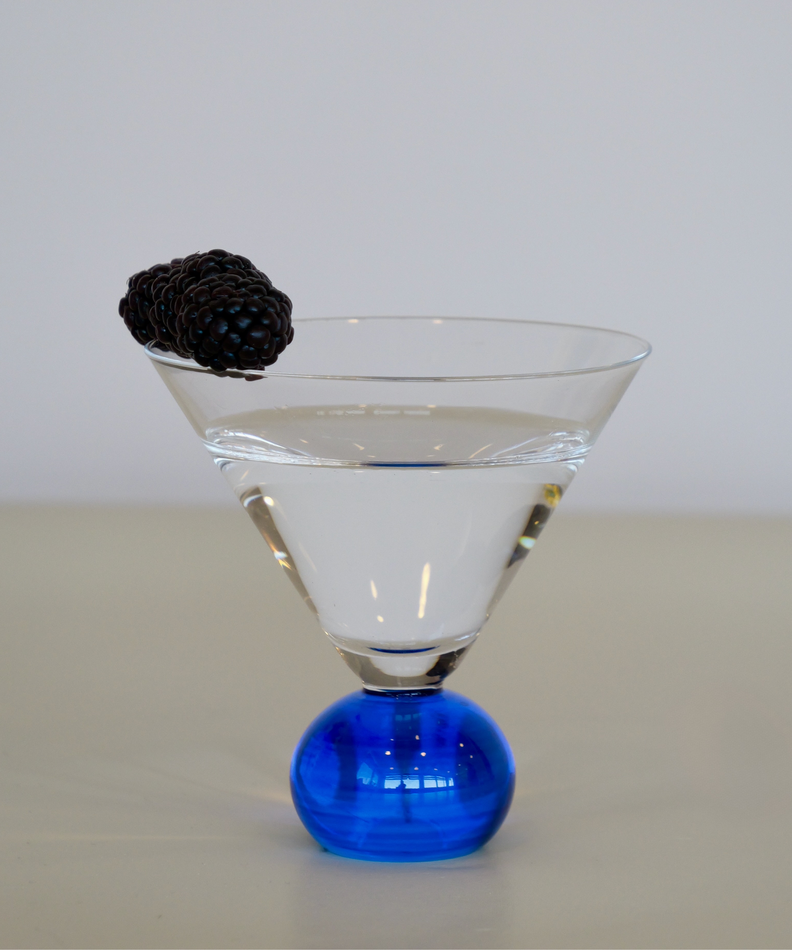 Set of two handcrafted cocktail glasses with blue bobble stems, ideal for martinis and aperitifs – elegant barware from Marla Primrose.