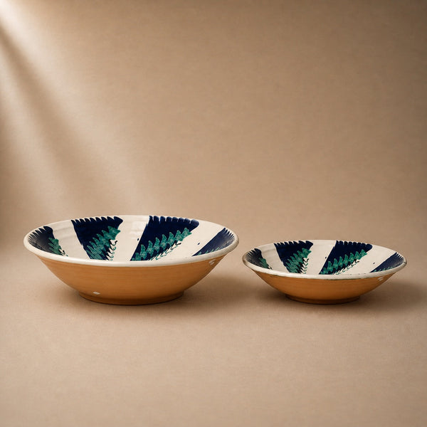 Two ceramic bowls with striped patterns on a beige background