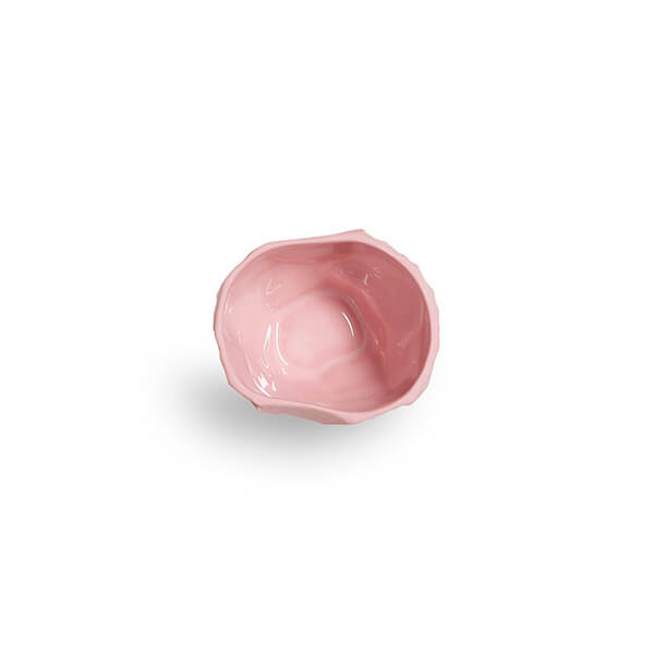 The Small Crockery Pink Bowl is crafted from pink stained earthenware, created in Stoke-on-Trent England, this piece is the product of 1882 Ltd.'s collaboration with Max Lamb