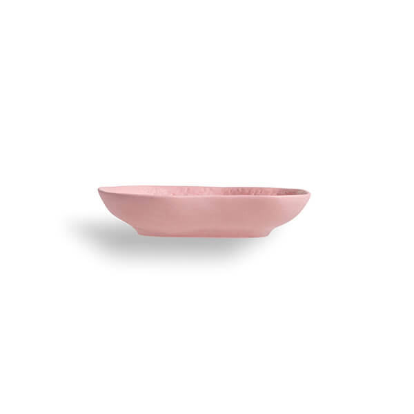 Side view of the small crockery pink platter, left unglazed to allow the chipped surface to show all it's nooks & crannys