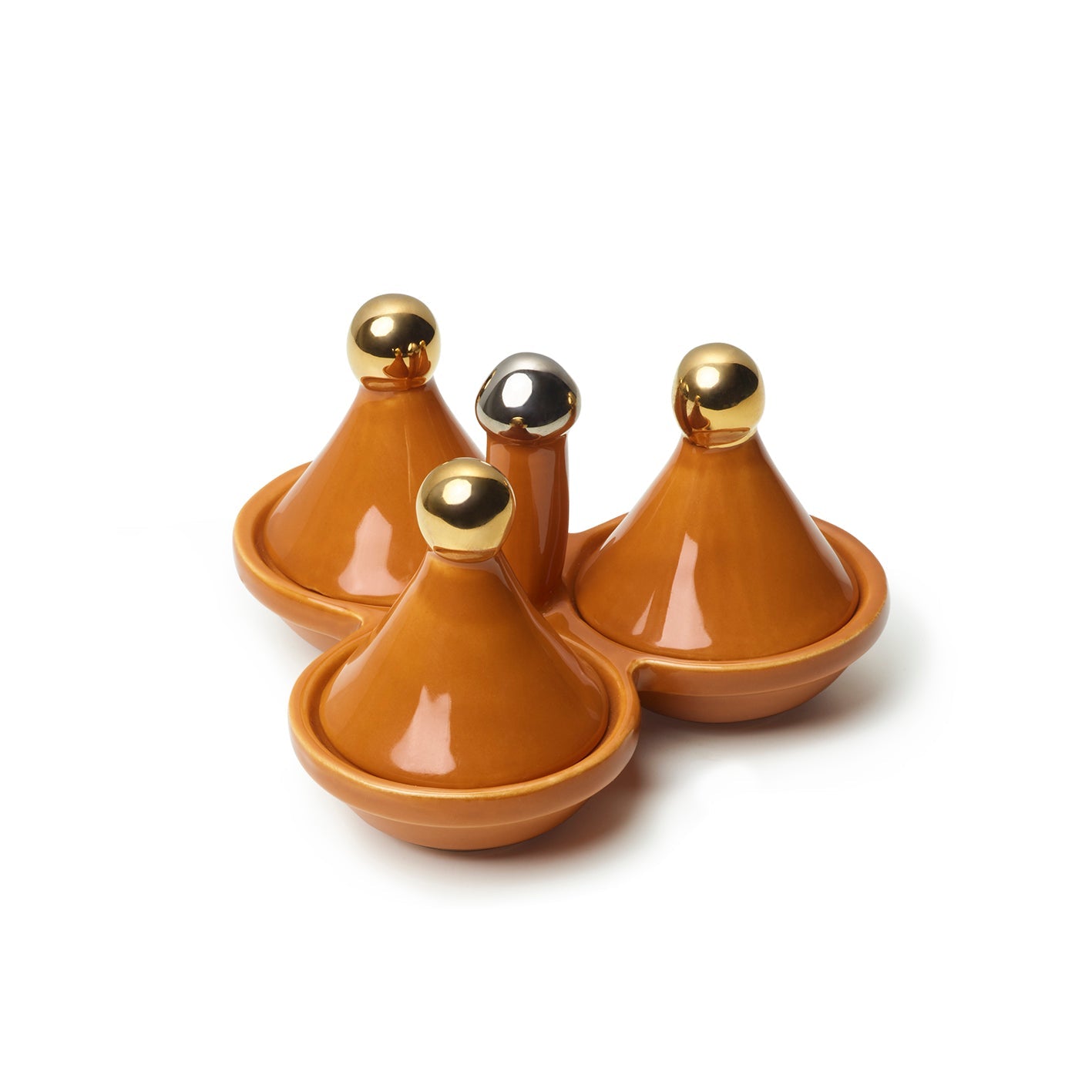 Three orange ceramic mini tagine lidded spice holders with gold-coloured handles on a white background.