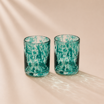 Two spotted glasses  on a beige background