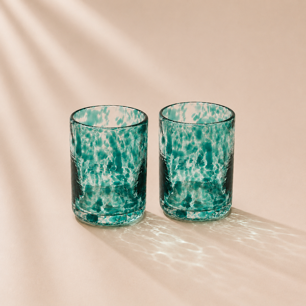 Two spotted glasses  on a beige background