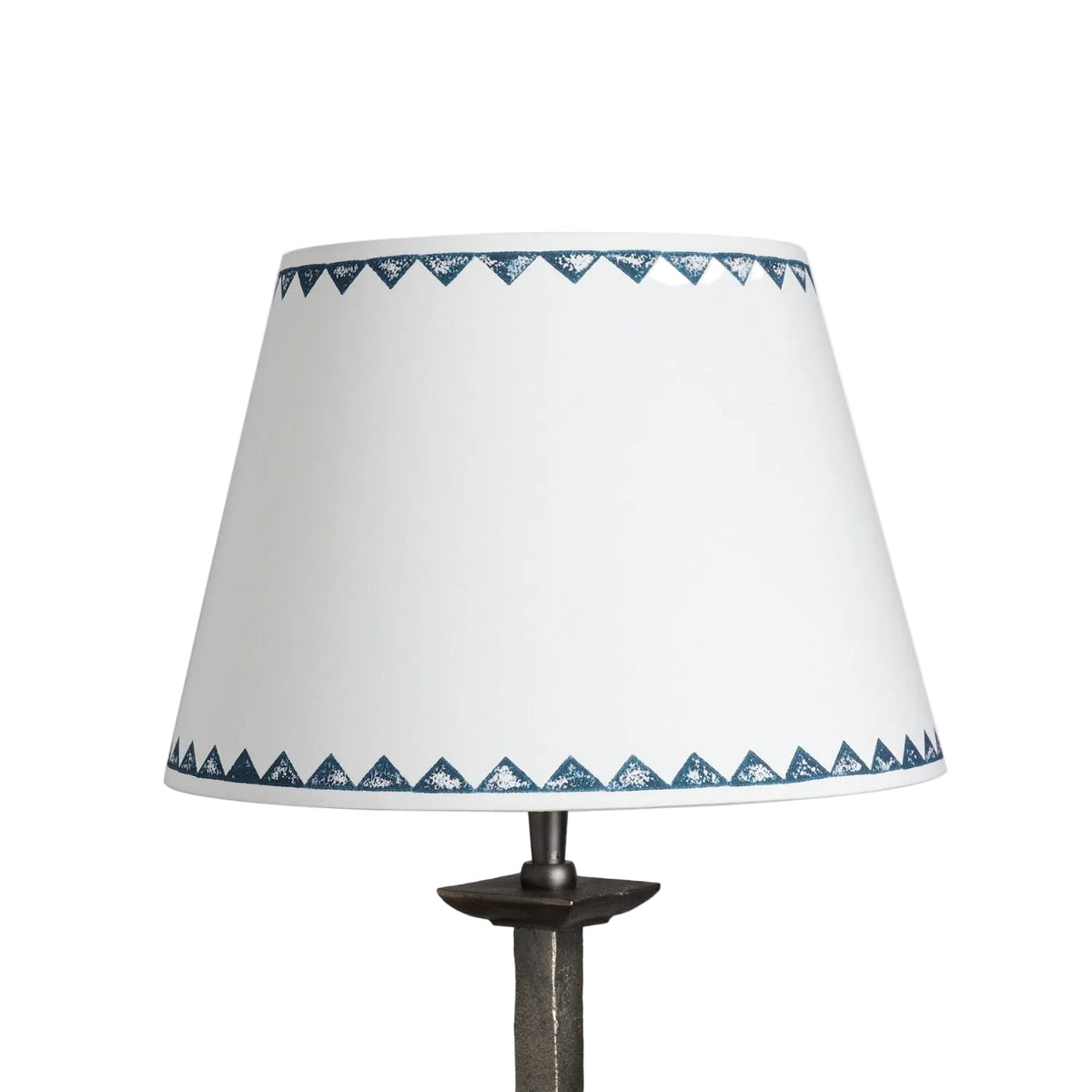 Product shot of cream empire lampshade with bold geometric lampshade design featuring a repeated navy blue triangle pattern along the edges, a stylish neutral lampshade.