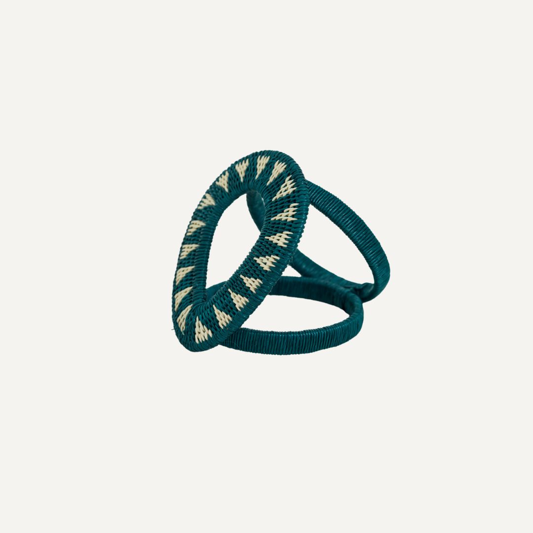 Gota Werregue napkin ring in teal, handwoven werregue palm, on a table setting