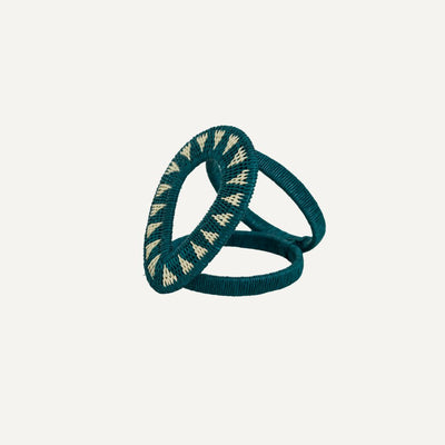 Gota Werregue napkin ring in teal, handwoven werregue palm, on a table setting