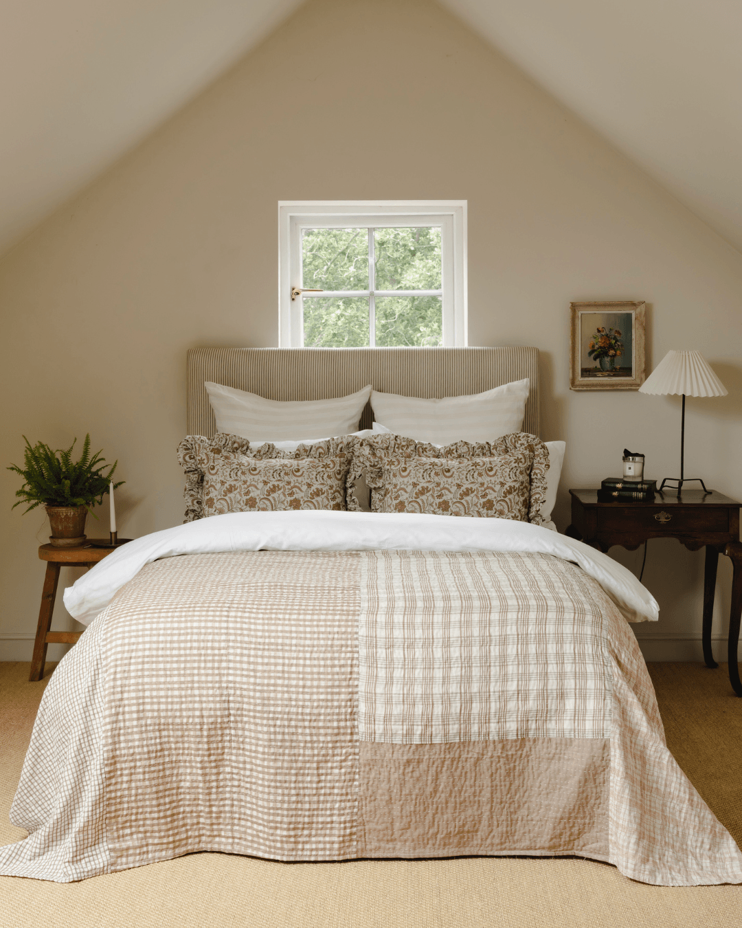 A bedroom image styled with The Old And New Companys patchwork house throw and the Betsy frill cushions
