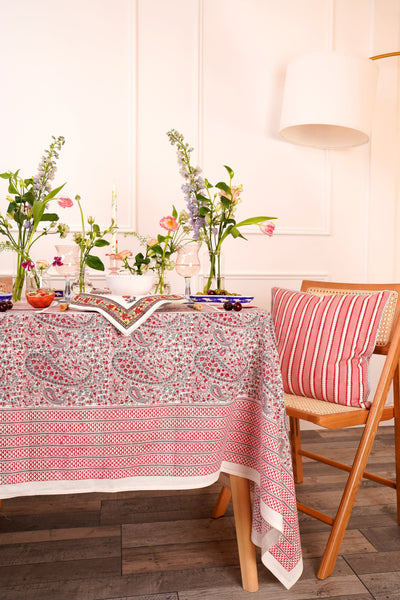 Pink block printed tablecloth with paisley pattern on a dining table styled with blcok printed napkins and table mats