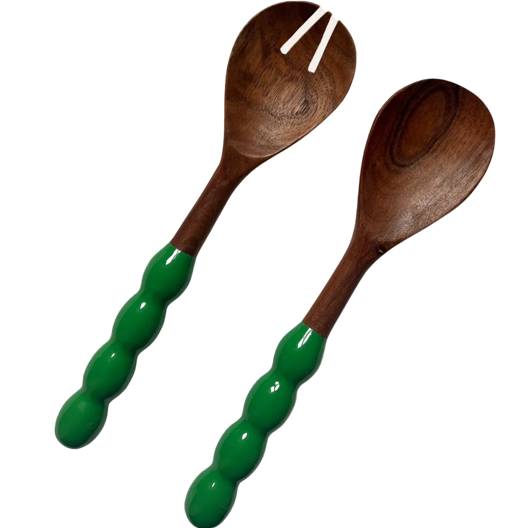Wooden salad servers with green handles on a white background