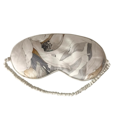 Sleep mask with abstract leaf pattern on a white background