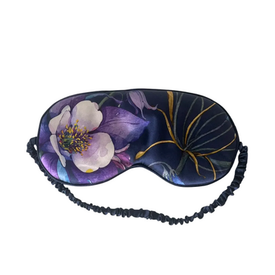 Floral patterned eye mask with black straps on a white background