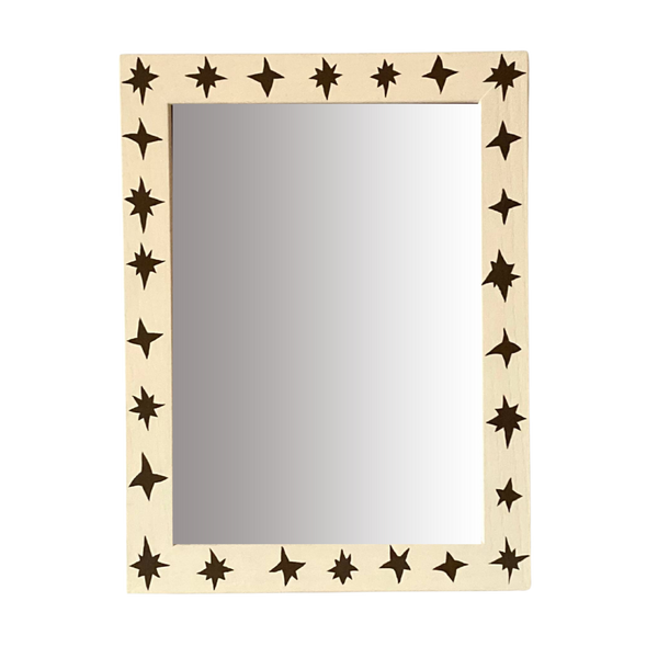 Mirror with star-shaped cutouts on a beige frame against a white background