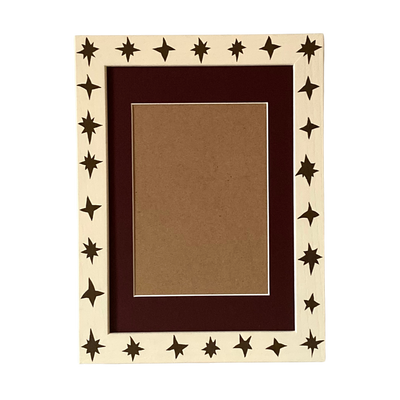 Decorative picture frame with star patterns on a white background