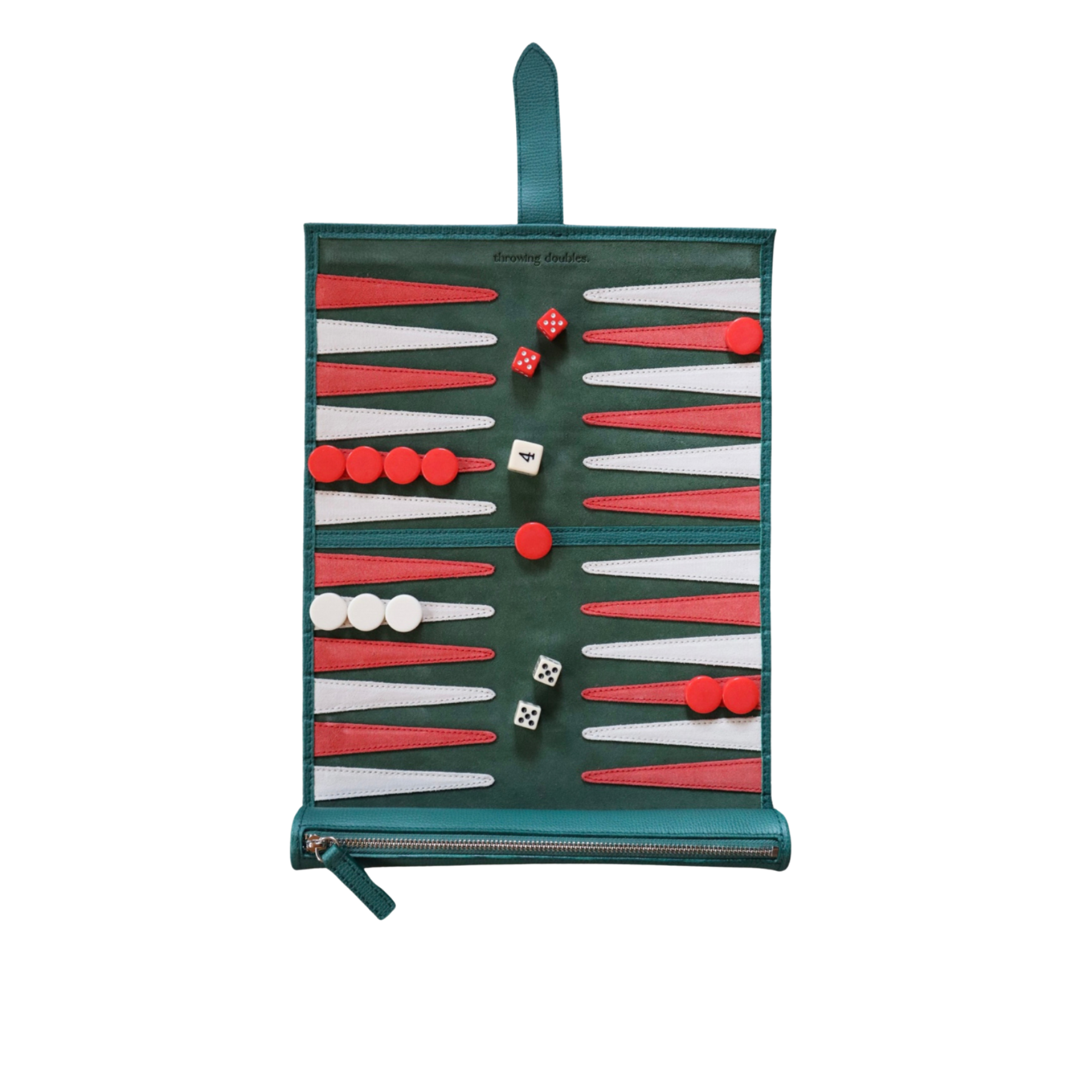 A travel backgammon board with a green, white, and red suede playing field, including red and white dice and a strap for carrying.