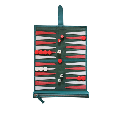 A travel backgammon board with a green, white, and red suede playing field, including red and white dice and a strap for carrying.