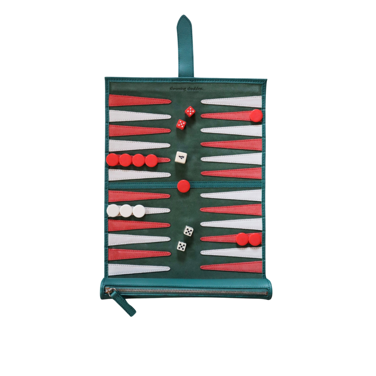 A travel backgammon board with a green, white, and red suede playing field, including red and white dice and a strap for carrying.
