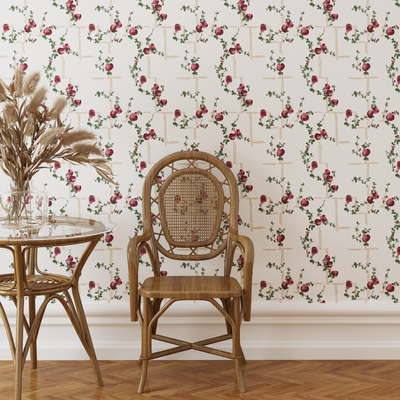 Rattan chair and table against a floral wallpapered wall