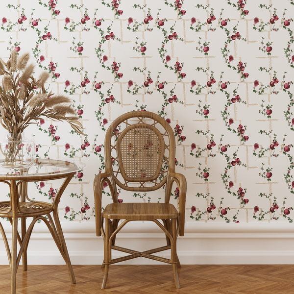Rattan chair and table against a floral wallpapered wall
