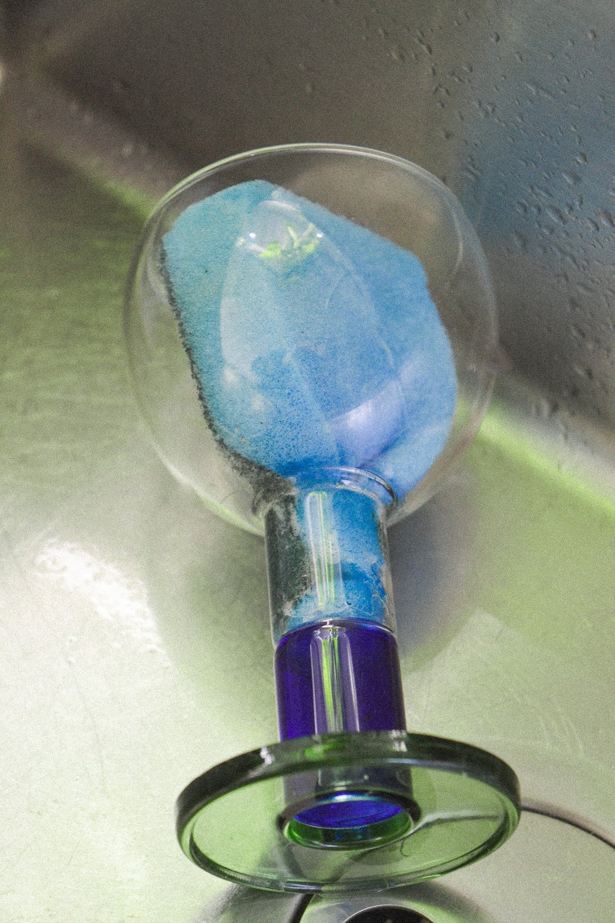 Wine candle glass in green and ink blue design, showcasing versatility as both a glass and candle holder.
