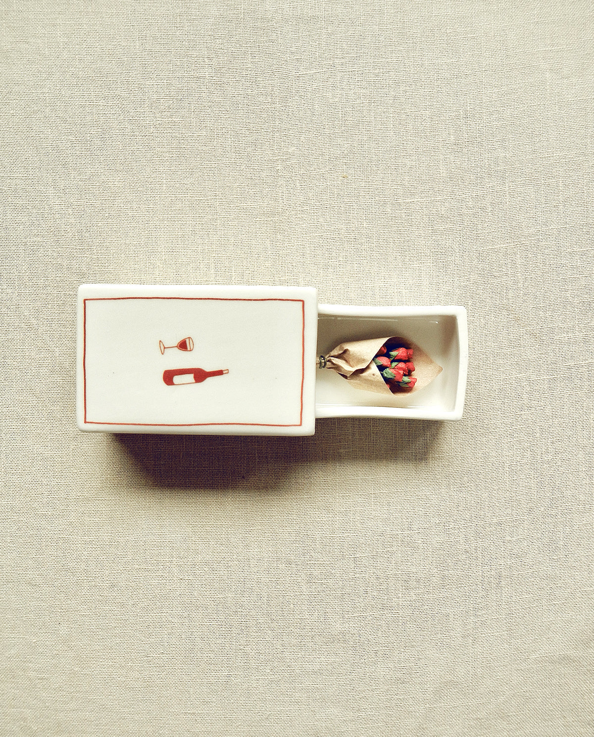 Hand-illustrated ceramic matchbox with wine bottle and glass illustration
