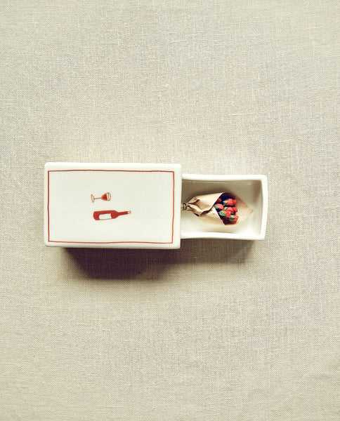 Hand-illustrated ceramic matchbox with wine bottle and glass illustration
