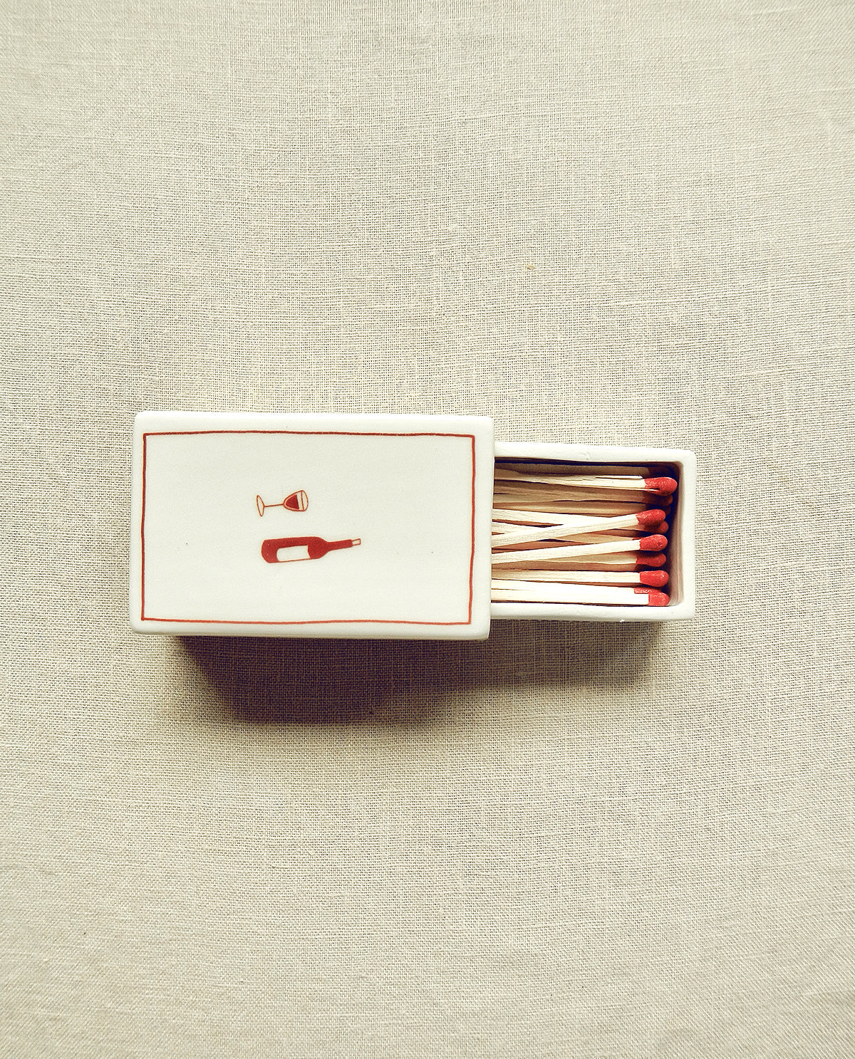 Hand-illustrated ceramic matchbox with wine bottle and glass illustration