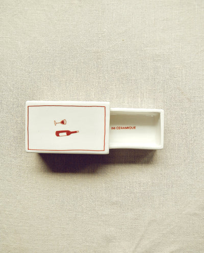 Hand-illustrated ceramic matchbox with wine bottle and glass illustration