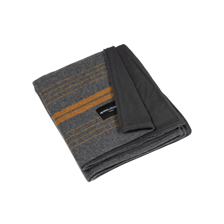 Product shot of city orange wool and wax picnic blanket with corner folded to show off waxed waterproof backing