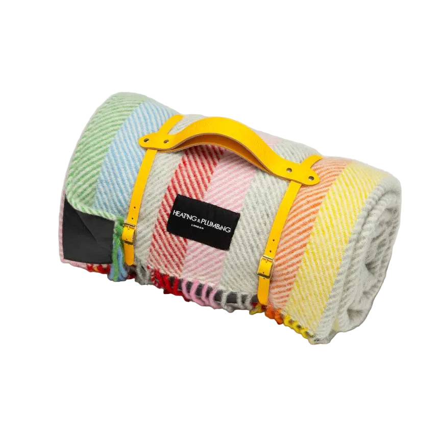 Colourful wool blanket in rainbow colours with a waterproof backing and a leather strap. Perfect for picnics.