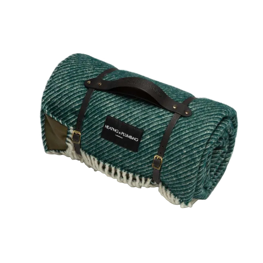 Green picnic wool blanket and waterproof backing with short black leather strap