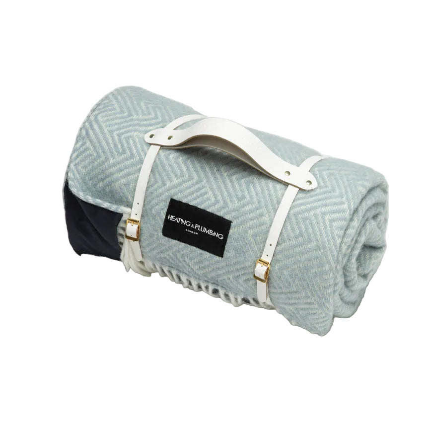 Duck egg blue wool picnic blanket with white leather strap. 