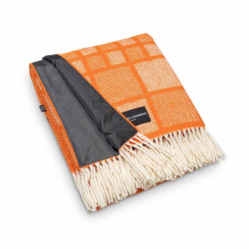 Orange wool picnic blanket with cream fringe, square mosaic pattern and waterproof navy backing, folded neatly – Heating & Plumbing London
