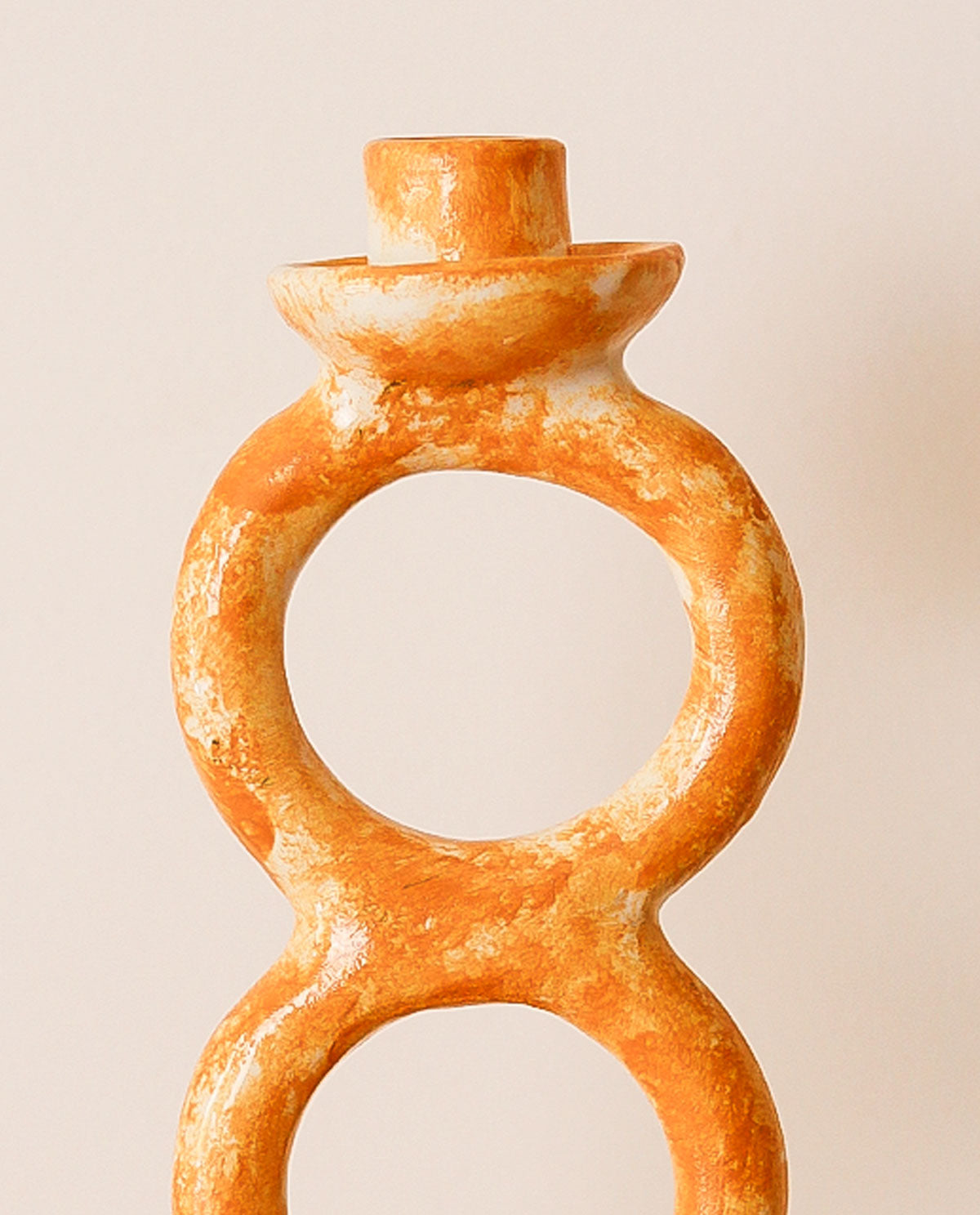 Decorative candle holder with a unique design on a beige background
