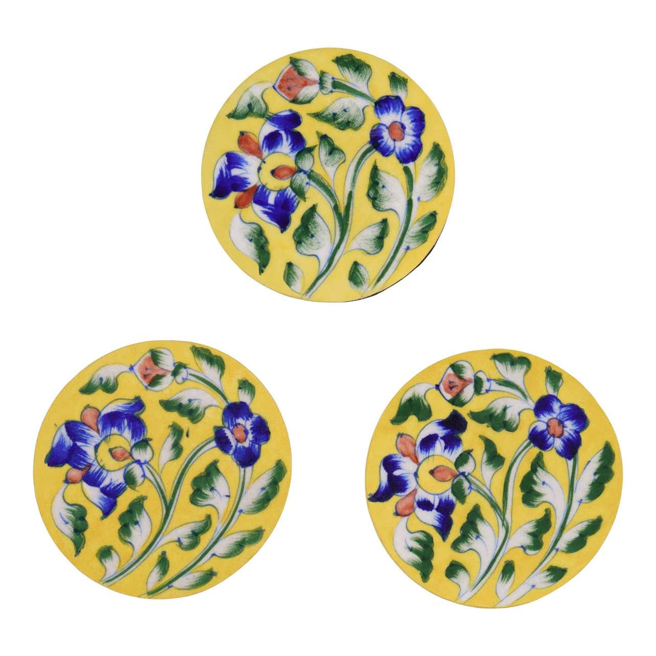 Three round ceramic coasters with a yellow background and blue floral patterns.
