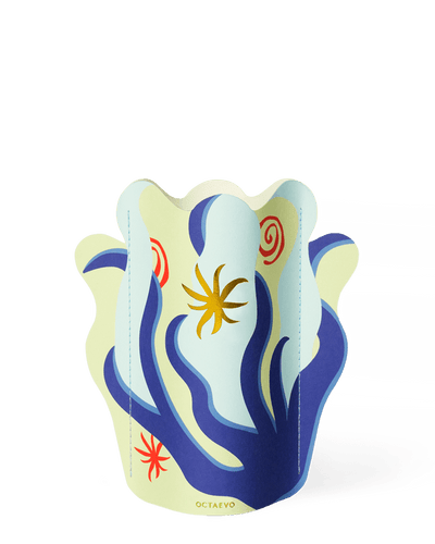 The OCTAEVO Amalfi Mini Paper Vase features abstract blue, yellow, and red shapes on a light background.