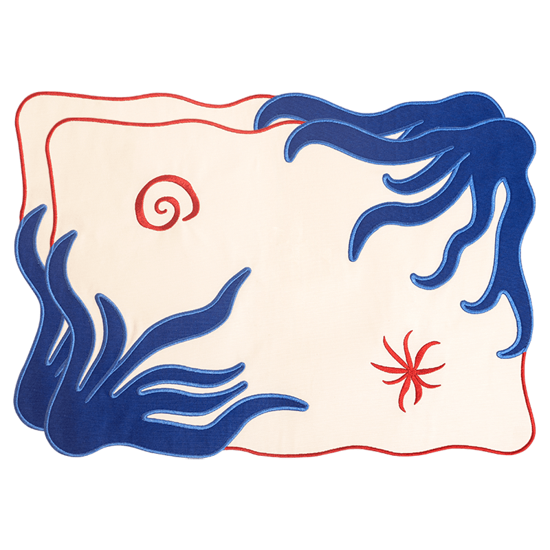 OCTAEVO Amalfi Placemats (Set of 2) feature abstract cream, blue waves, red swirls, and an embroidered-look border.