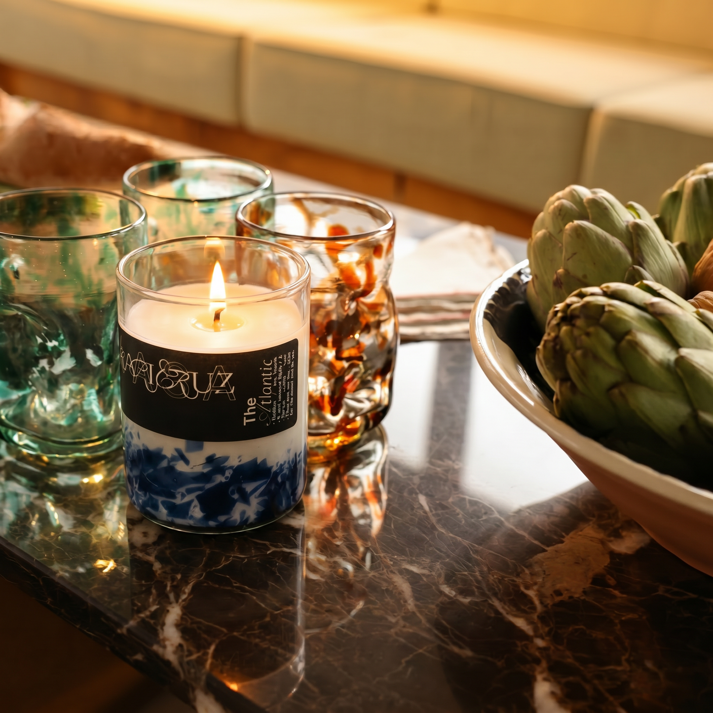 candle set on a table with deflated glasses - lifestyle