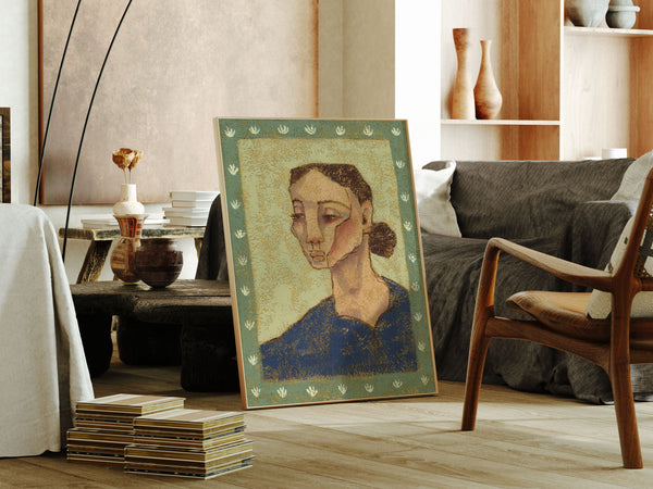 Framed artwork of a woman's portrait in a living room setting with furniture and decor.