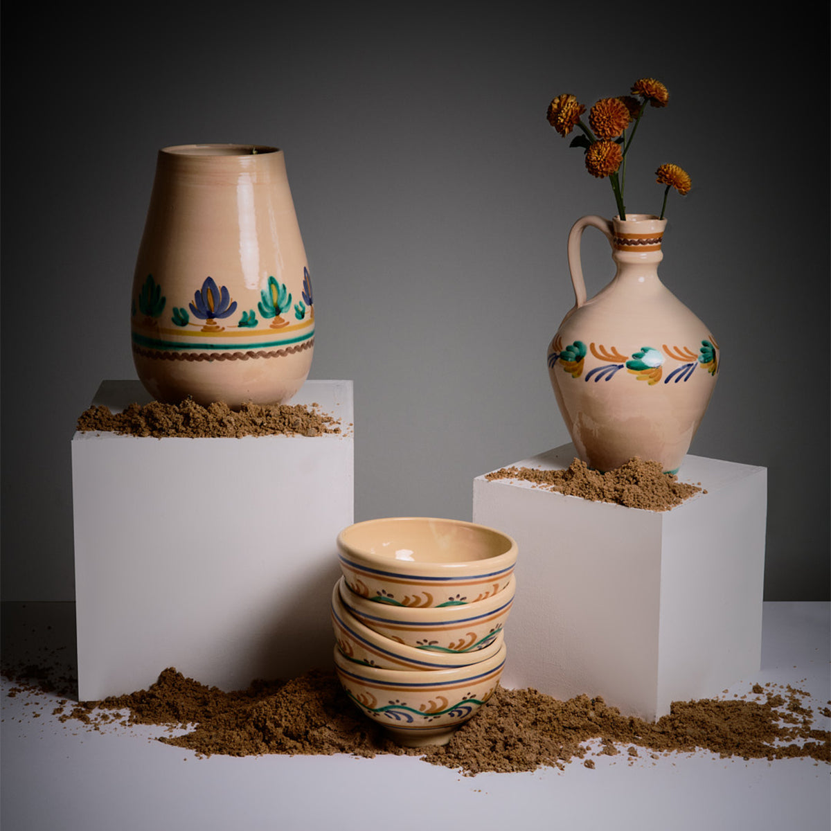 Set of ceramic vases and bowls with decorative patterns on a dark background -lifestyle