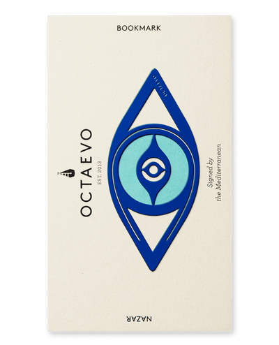 The Bookmark Nazar by OCTAEVO is a blue and turquoise Mediterranean eye brass bookmark on a cream card.