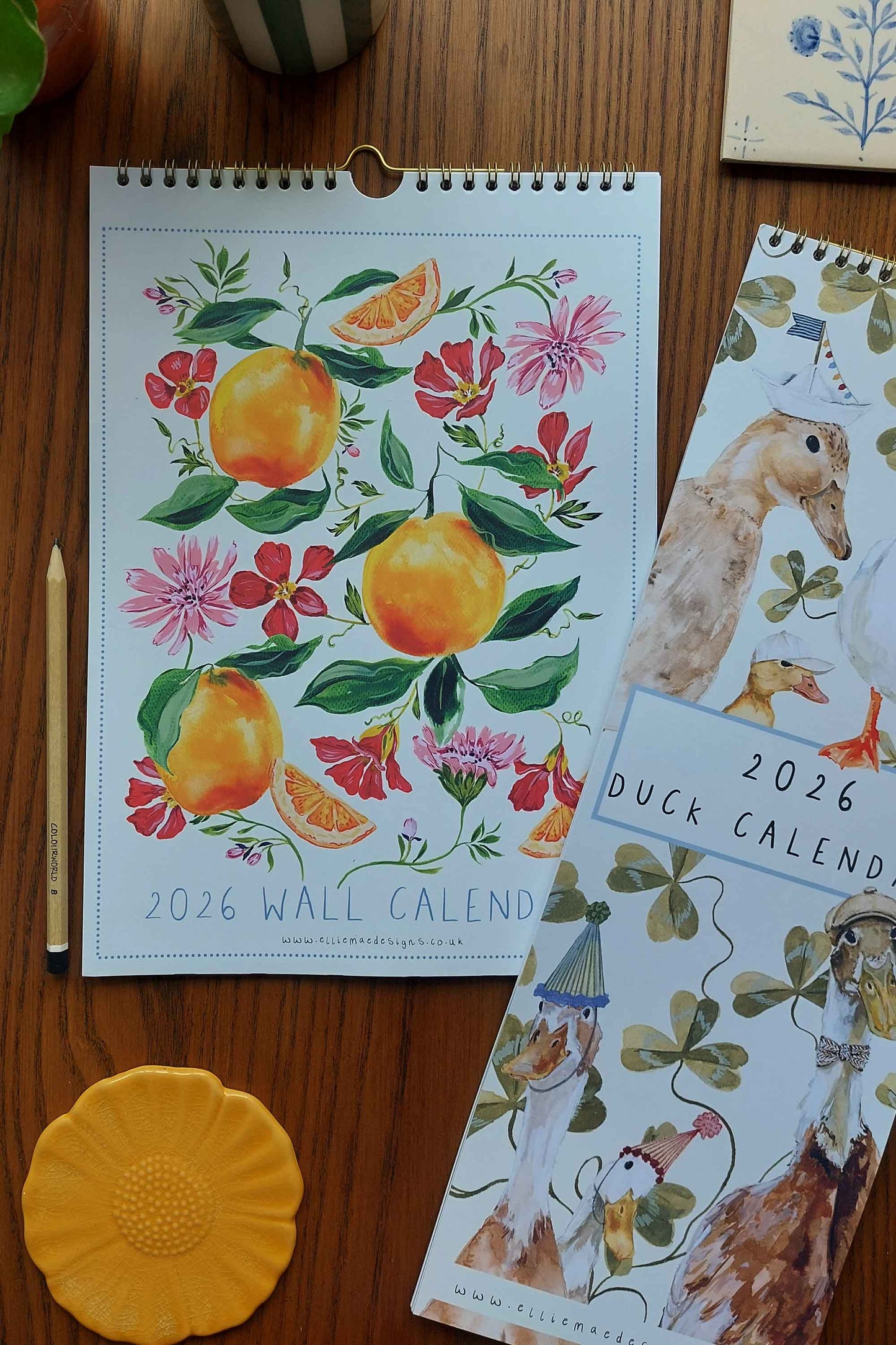 2026 wall calendar with floral design on a wooden surface