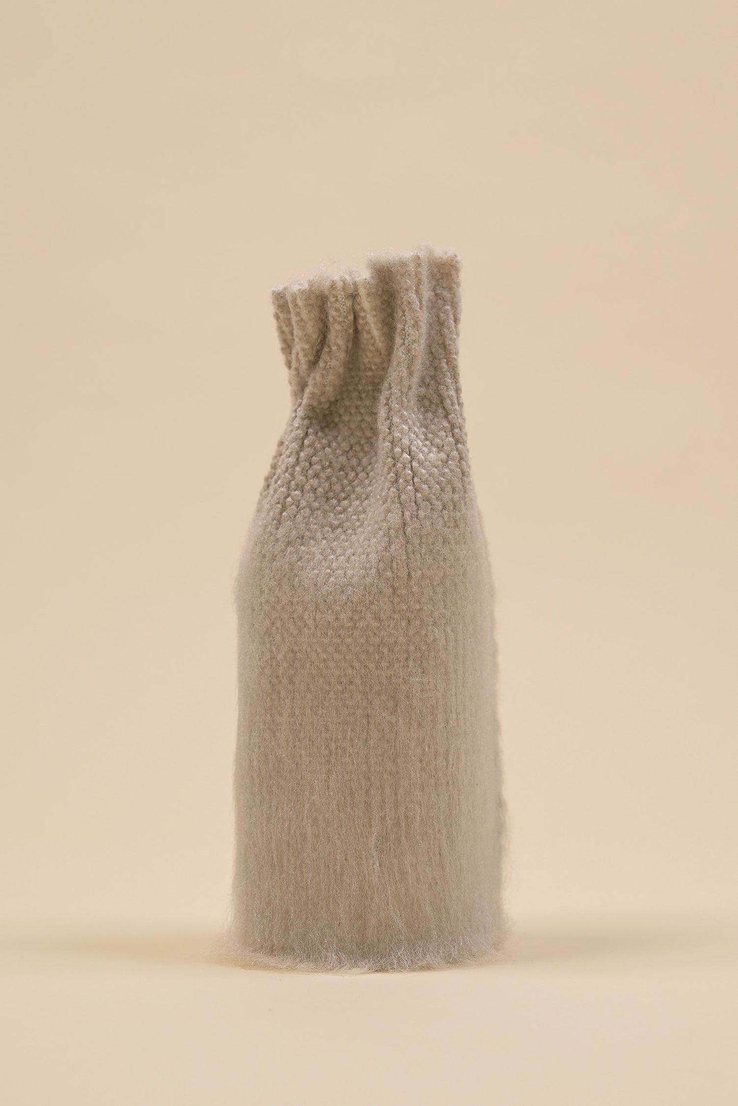 front view of beige knit textile vase in brushed silk and organic cotton with beige background