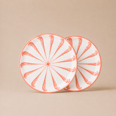 Two ceramic plates with a decorative pattern on a beige background