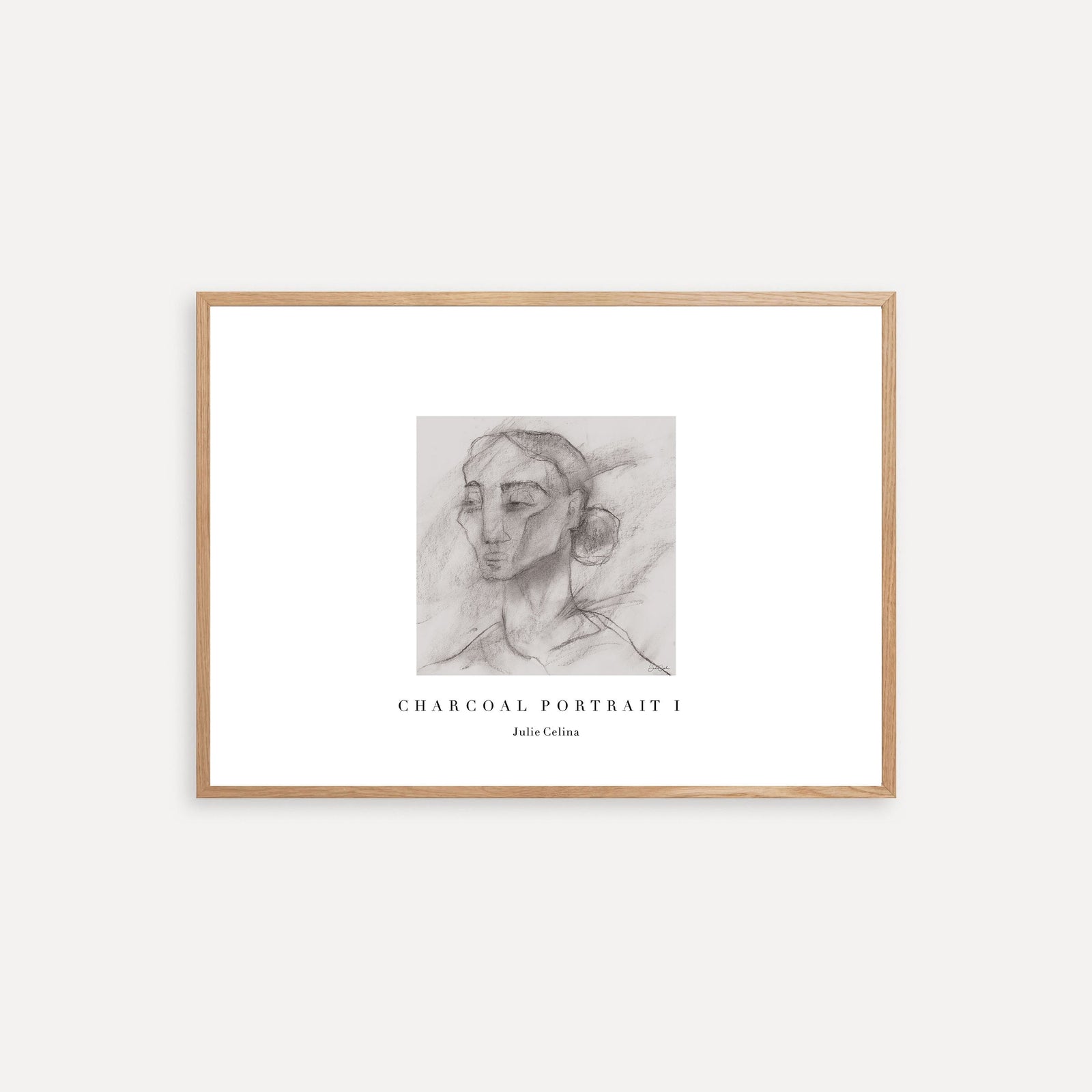 Framed charcoal portrait art on a white wall
