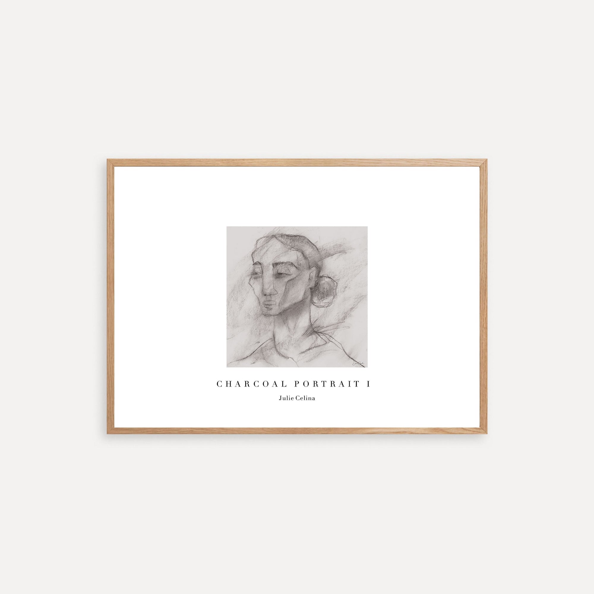 Framed charcoal portrait art on a white wall