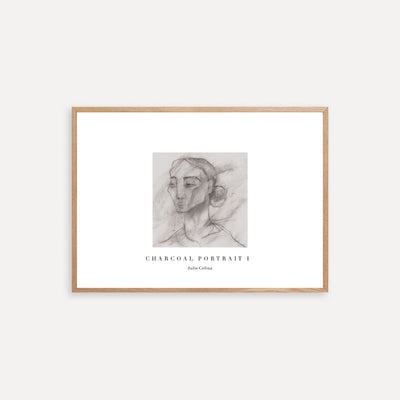 Framed charcoal portrait art on a white wall