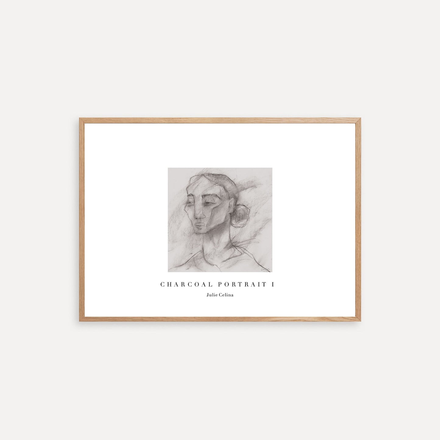 Framed charcoal portrait art on a white wall