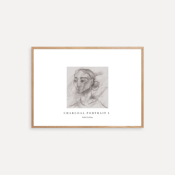 Framed charcoal portrait art on a white wall