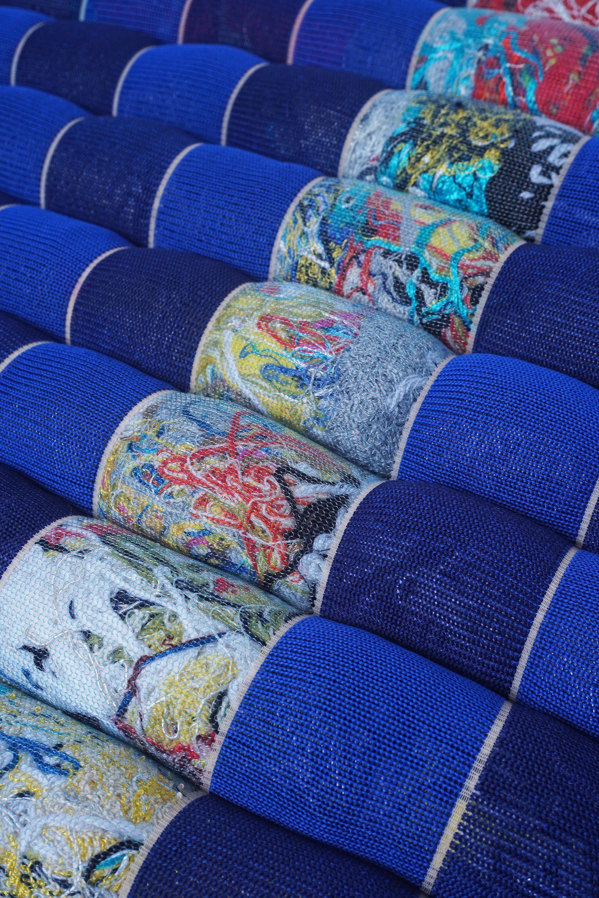 closeup of blue/navy knit checkered seat cushion with upcycled materials