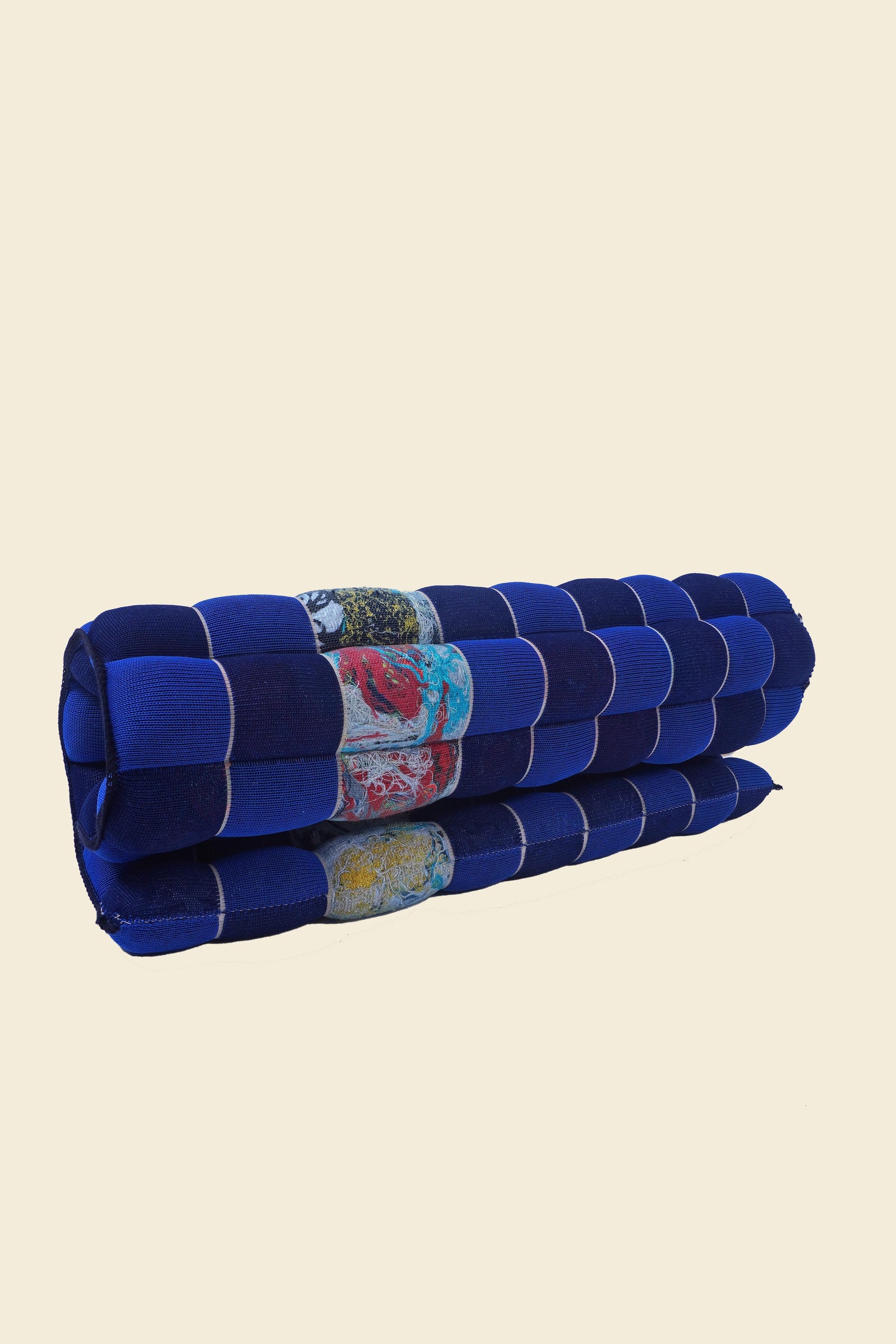 rolled up blue/navy knit checkered seat cushion with upcycled materials